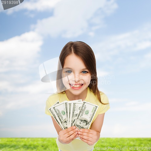 Image of smiling little girl with dollar cash money