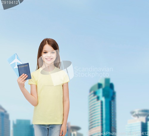 Image of smiling little girl with ticket and passport