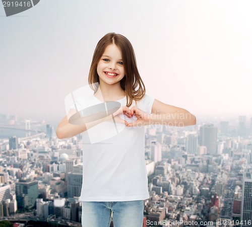 Image of smiling little girl in white blank t-shirt