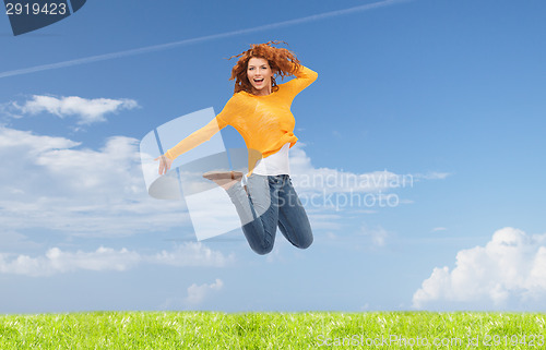 Image of smiling young woman jumping in air