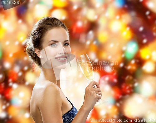 Image of smiling woman holding glass of sparkling wine