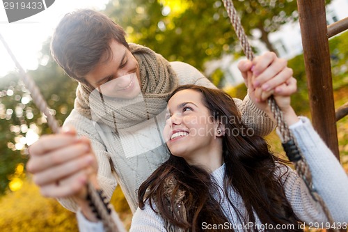 Image of smiling couple hugging in autumn park