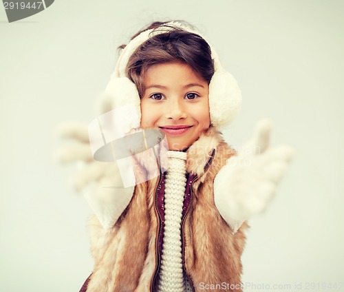Image of happy littl girl in winter clothes