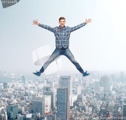 Image of smiling young man jumping in air