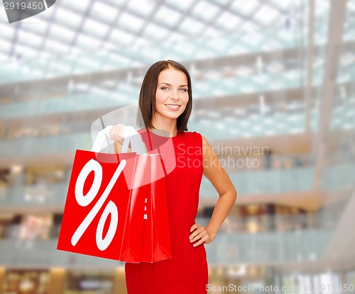 Image of woman in red dress with shopping bags