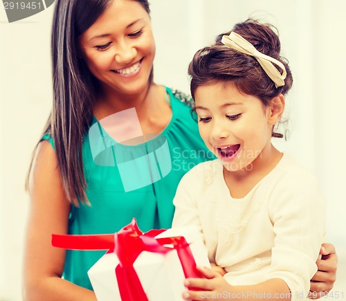 Image of happy mother and child girl with gift box