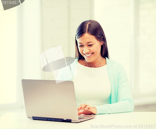 Image of international student girl with laptop at school