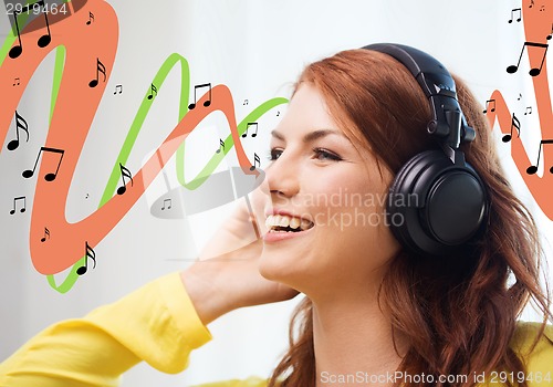 Image of smiling young girl in headphones at home