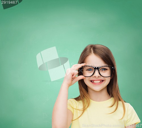 Image of smiling cute little girl in black eyeglasses