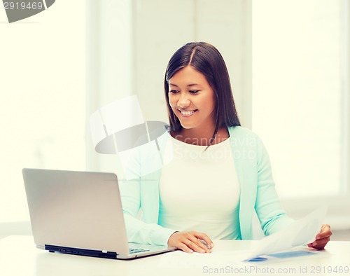 Image of asian businesswoman with laptop and documents