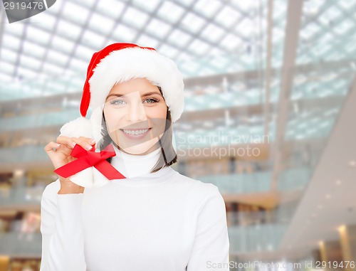 Image of smiling woman in santa helper hat and jingle bells