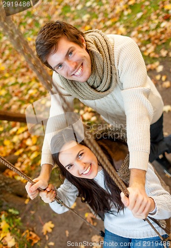 Image of smiling couple hugging in autumn park