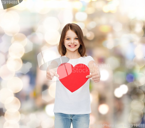 Image of beautiful little girl sitting at table