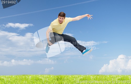 Image of smiling young man jumping in air