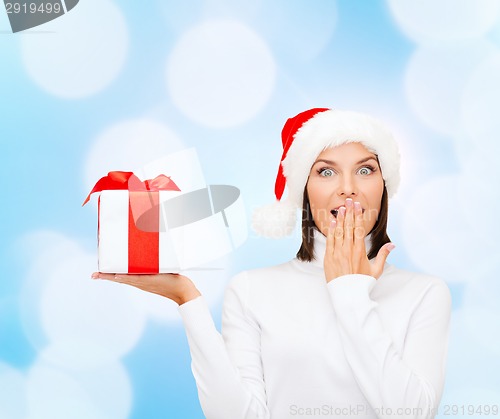 Image of smiling woman in santa helper hat with gift box