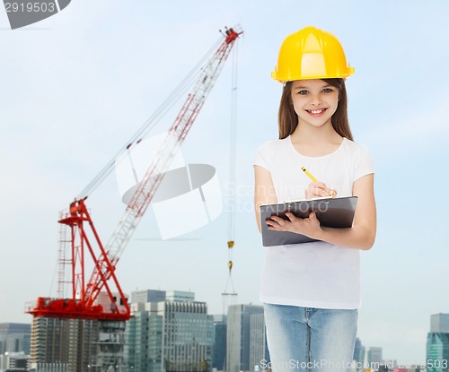 Image of smiling little girl in hardhat with clipboard