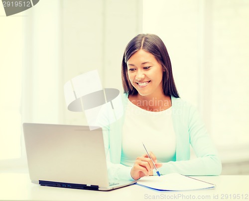 Image of asian businesswoman with laptop and documents