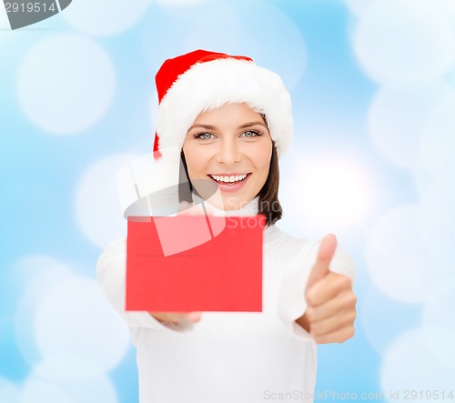 Image of woman in santa helper hat with blank red card