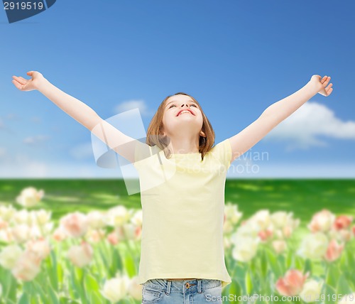 Image of smiling teenage girl with raised hands