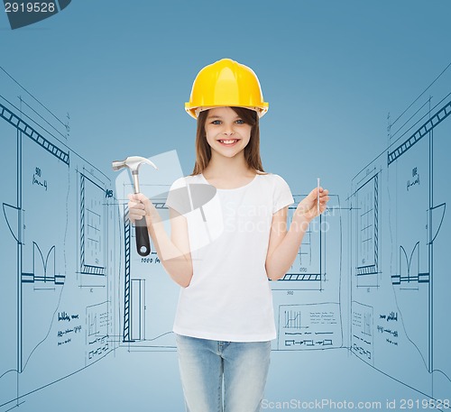 Image of smiling little girl in hardhat with hammer