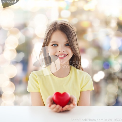 Image of beautiful little girl sitting at table