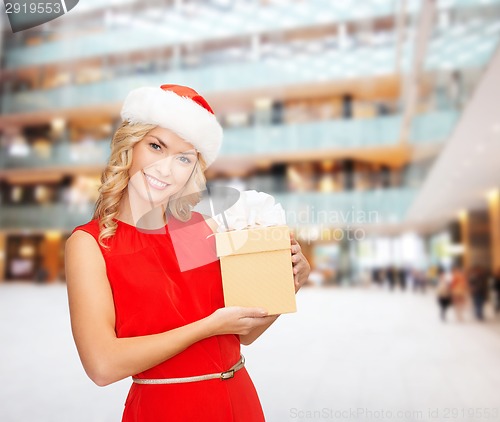 Image of smiling woman in santa helper hat with gift box