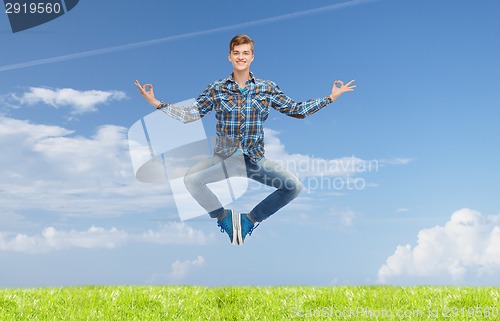 Image of smiling young man jumping in air