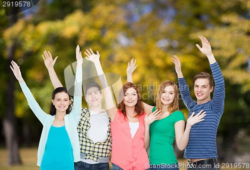 Image of group of smiling students waving hands