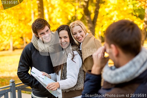 Image of group of friends with map outdoors