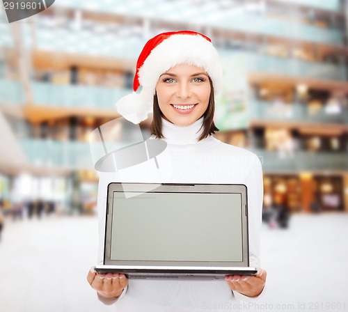 Image of woman in santa helper hat with laptop computer