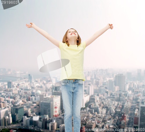 Image of smiling teenage girl with raised hands