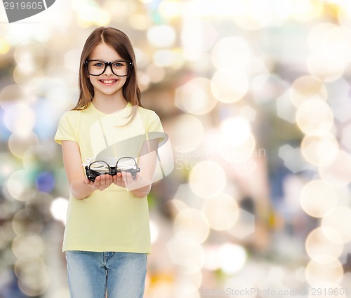 Image of smiling cute little girl in black eyeglasses