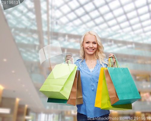 Image of smiling woman with many shopping bags