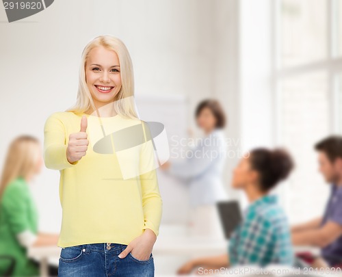 Image of smiling girl in casual clothes showing thumbs up