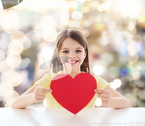 Image of beautiful little girl sitting at table