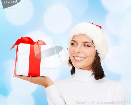 Image of smiling woman in santa helper hat with gift box