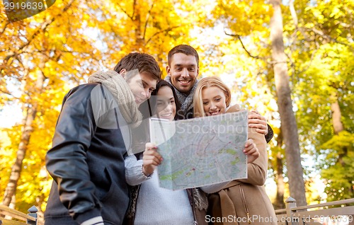 Image of group of friends with map outdoors