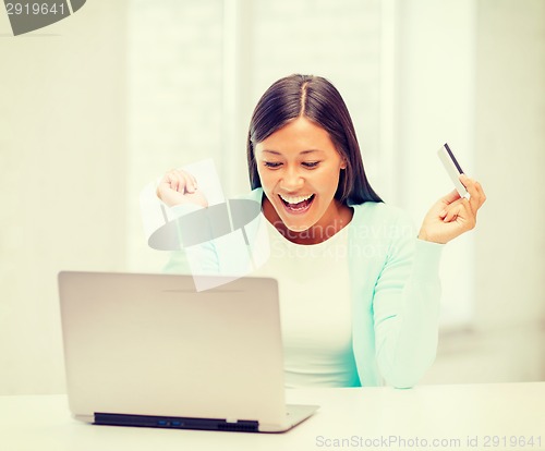 Image of businesswoman with laptop and credit card