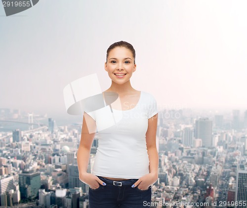 Image of smiling young woman in blank white t-shirt