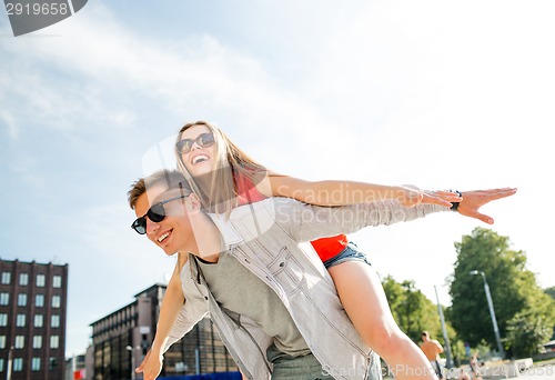 Image of smiling couple having fun in city