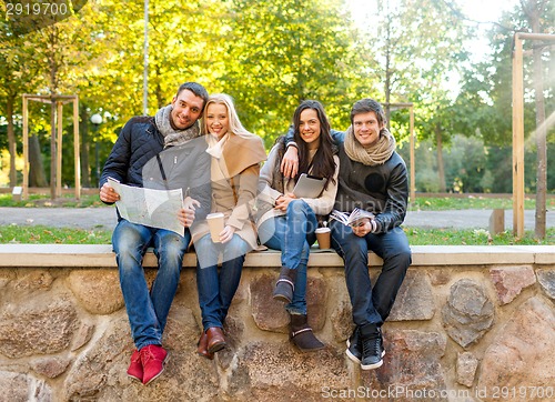 Image of group of friends with map outdoors