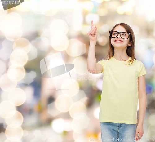 Image of smiling cute little girl in black eyeglasses