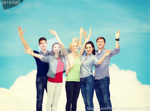 Image of group of smiling students waving hands