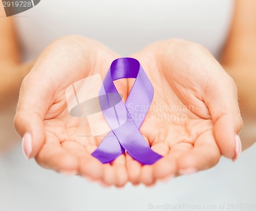 Image of hands holding purple awareness ribbon