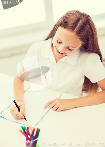 Image of little student girl drawing at school