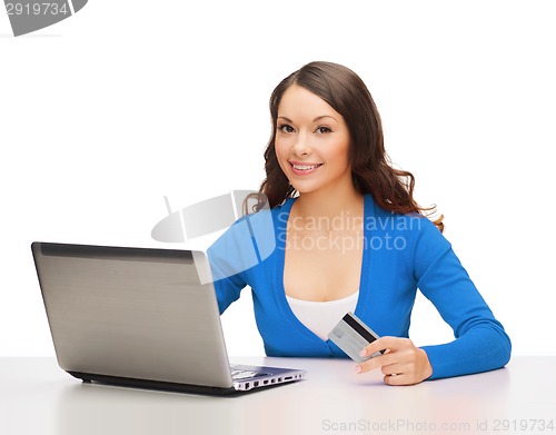 Image of happy woman with laptop computer and credit card