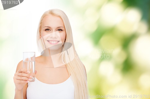 Image of young smiling woman with glass of water