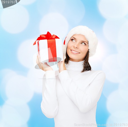 Image of smiling woman in santa helper hat with gift box