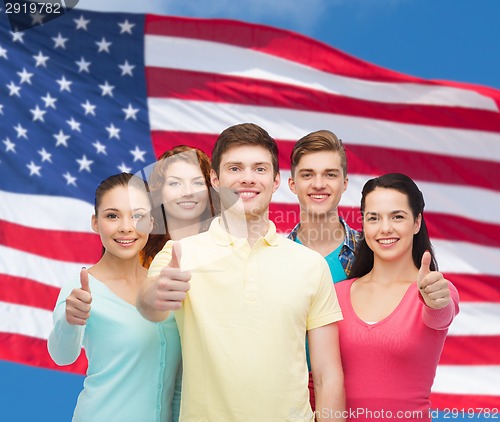 Image of group of smiling teenagers over american flag