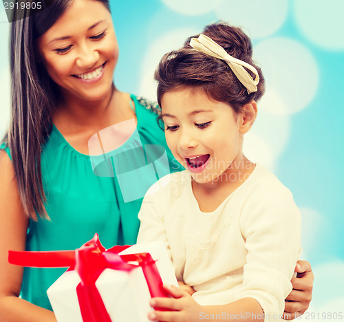 Image of happy mother and child girl with gift box